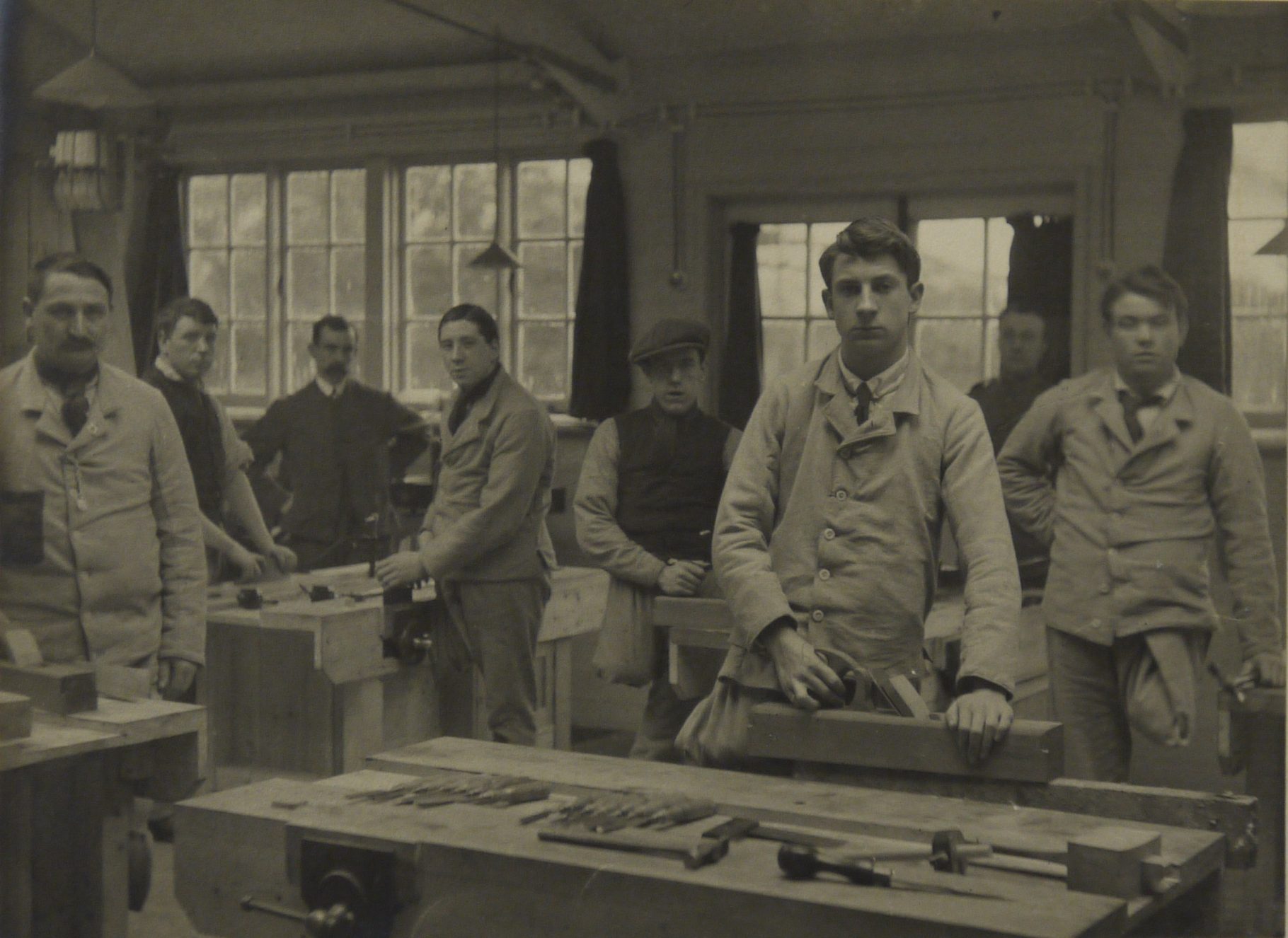 Photo of a group of wounded servicemen with leg amputations in a carpentry workshop