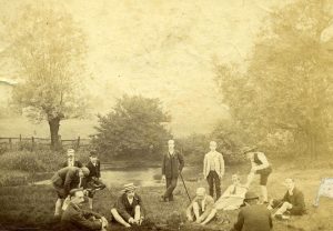 Photo of male ramblers resting by a pond