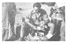 Photo of a soldier opening a parcel
