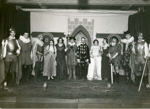 Cast of a play on stage in costume
