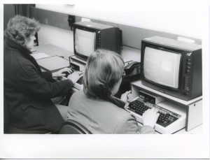 Photo of two people using computers